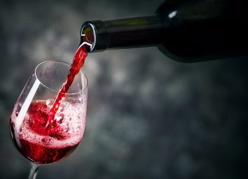 red wine being poured from bottle into glass