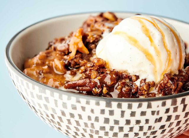 slow cooker carrot cake topped with vanilla ice cream in bowl