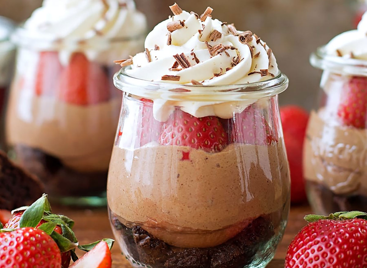 strawberry nutella cheesecake with whipped cream in glass
