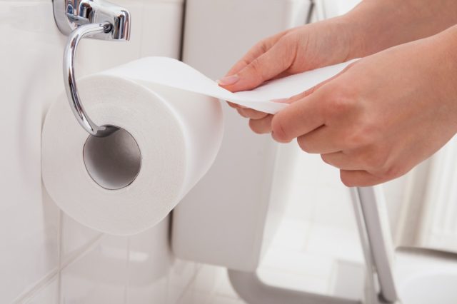 Person's Hand Using Toilet Paper 