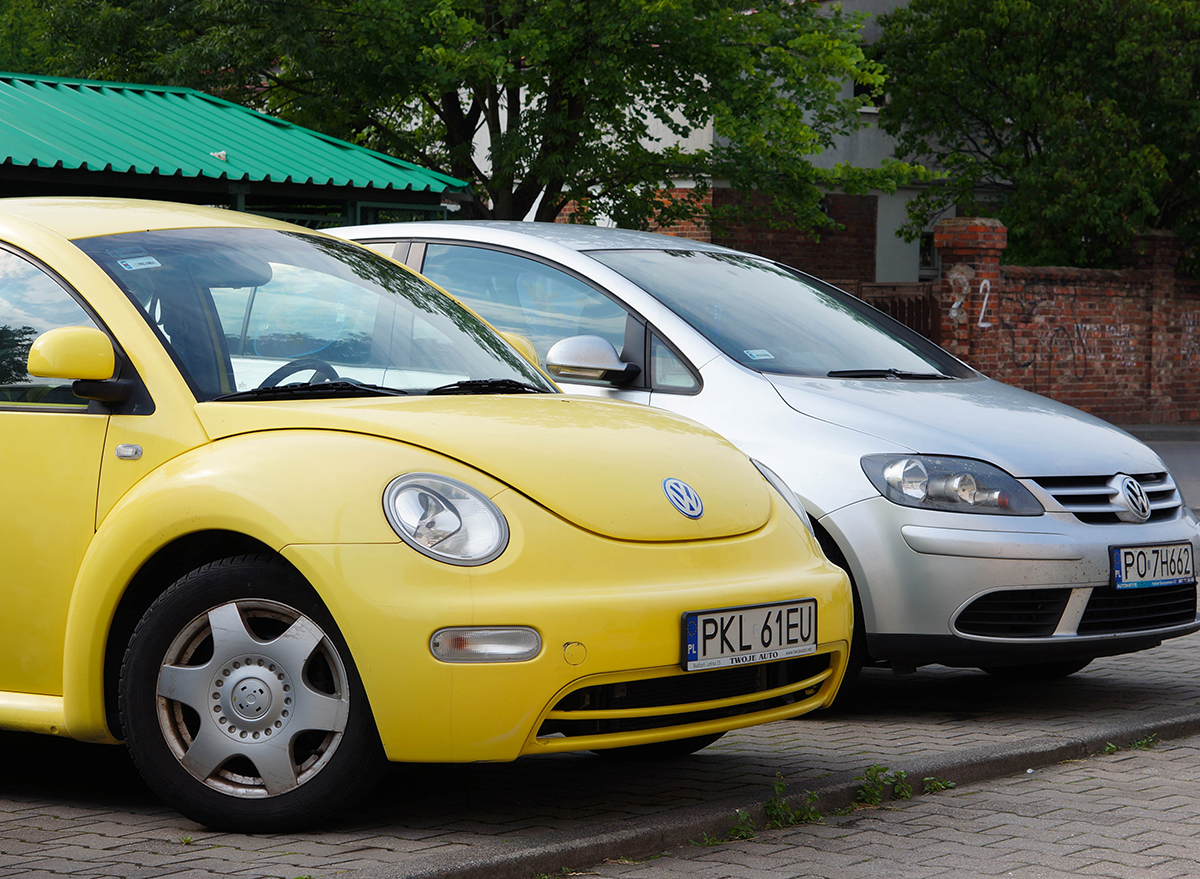yellow volkswagen beetle in parking spot