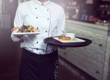 waiter carrying plates of food