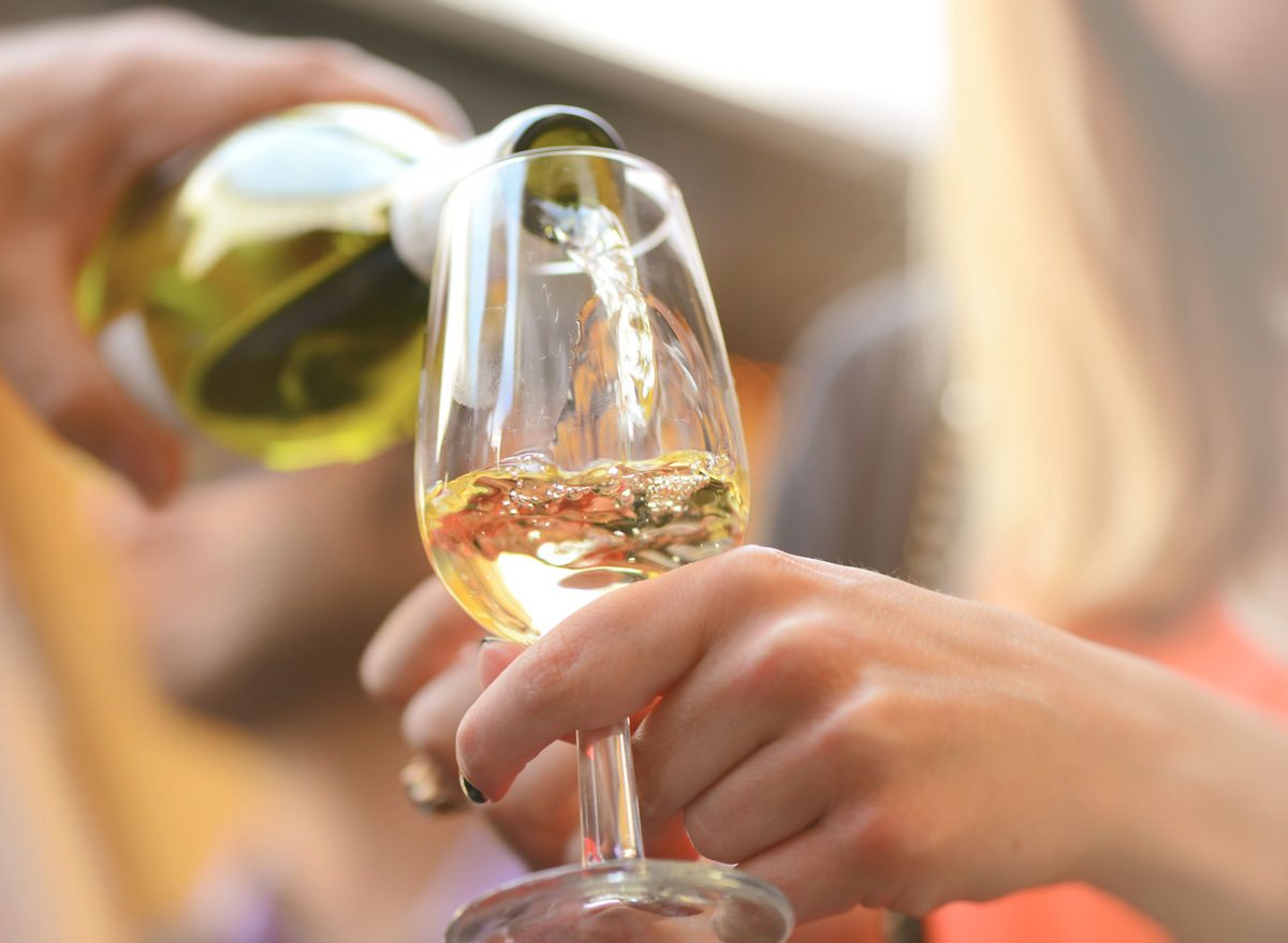 Woman pouring glass of white wine