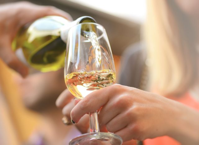 Woman pouring glass of white wine