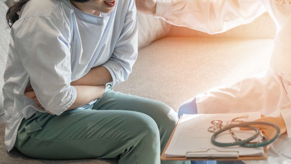 Abdominal pain patients woman having medical examination with doctor on stomach illness