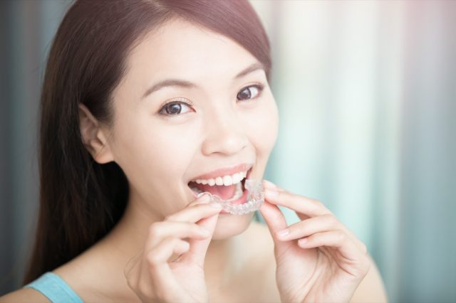 oman smile happily with invisible braces