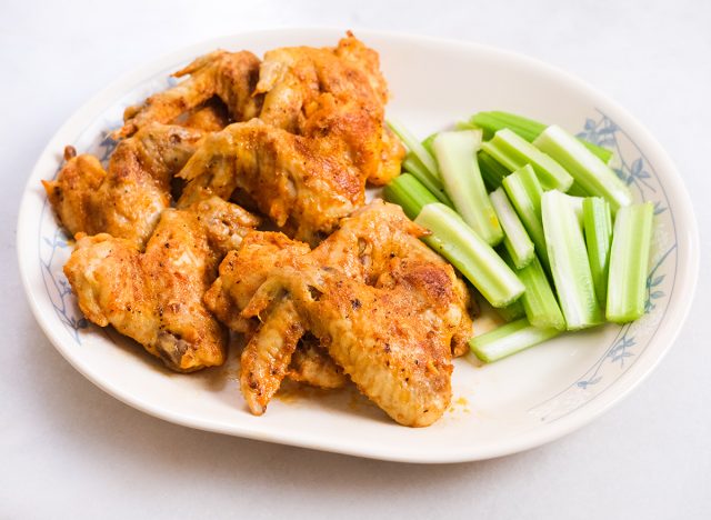 buffalo chicken wings and celery on a plate