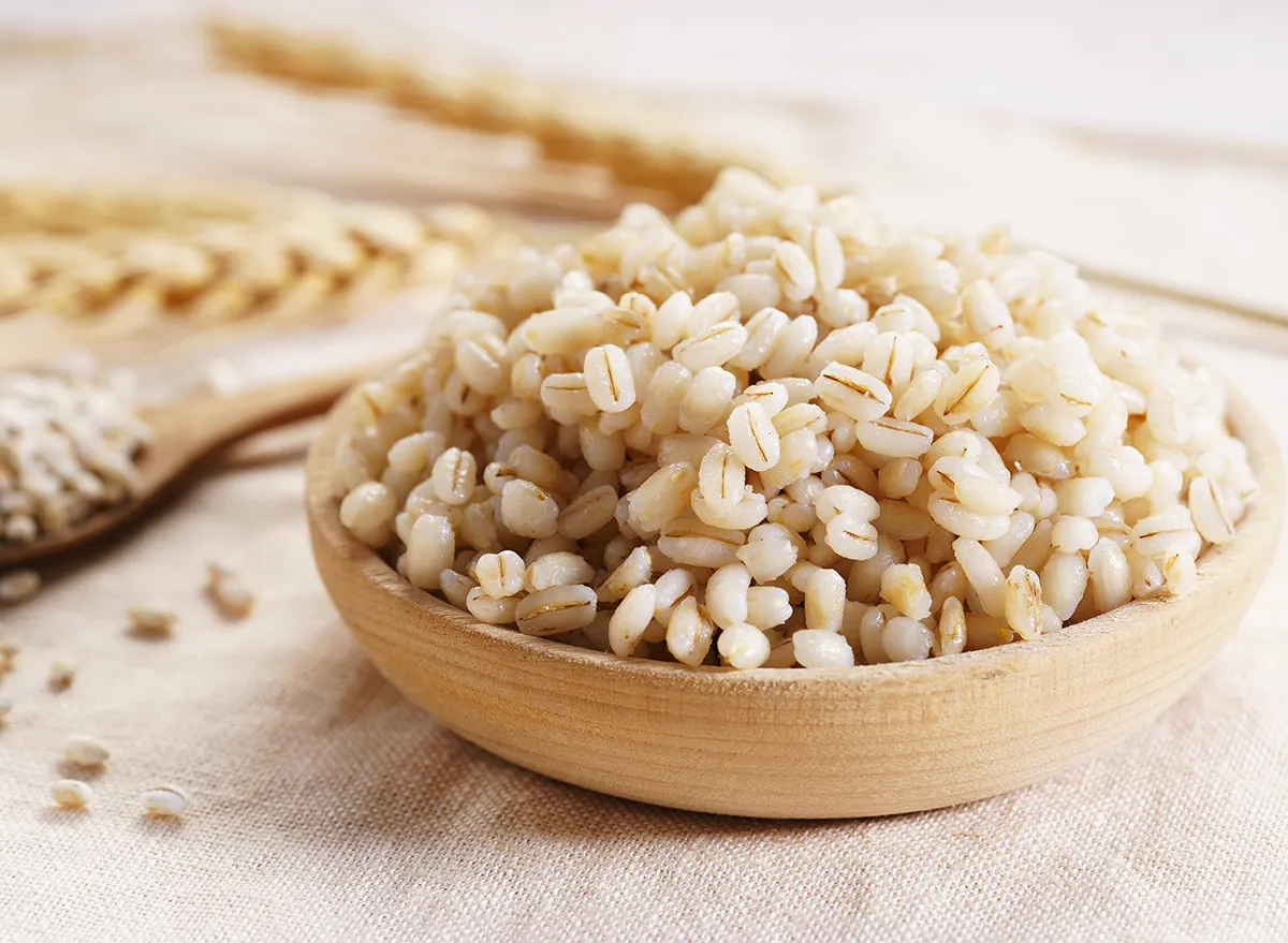 cooked barley in wooden bowl