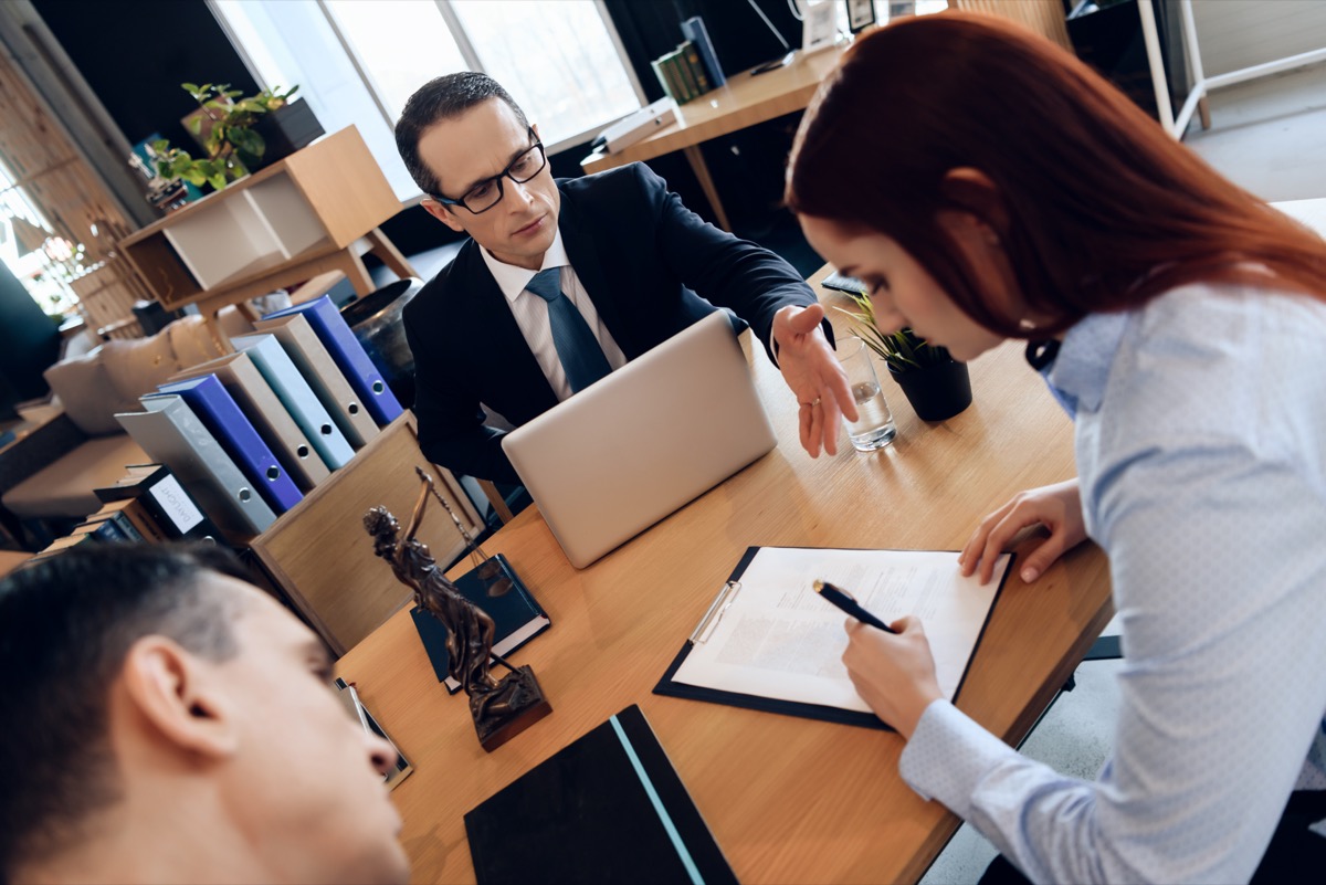 Husband and wife are signing divorce settlement