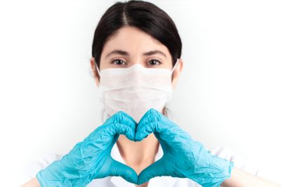 medicine doctor wearing face mask and blue scrubs standing corporate in health care work concept