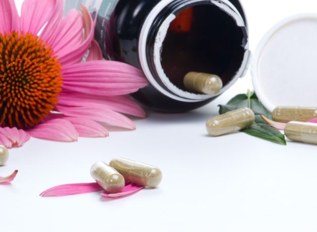 Echinacea extract pills and fresh Echinacea flowers