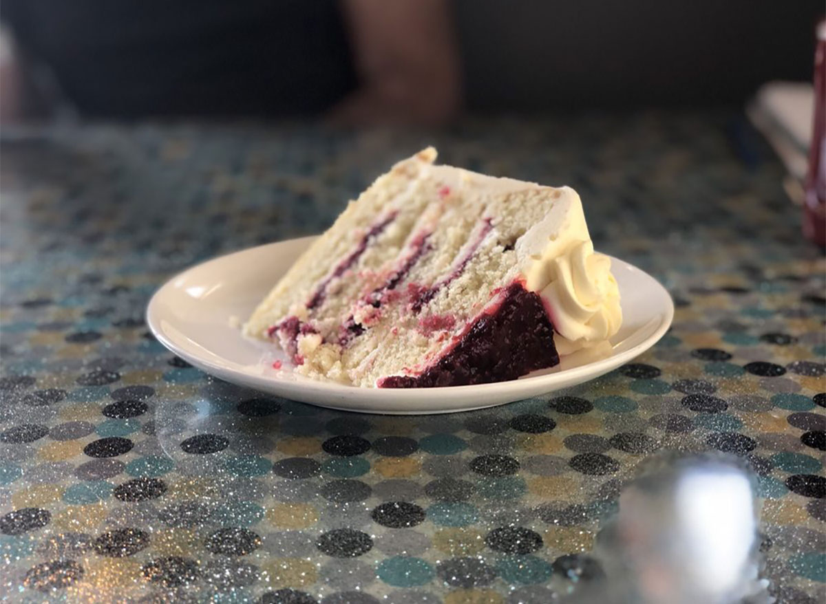 slice of lemon raspberry cake on white plate