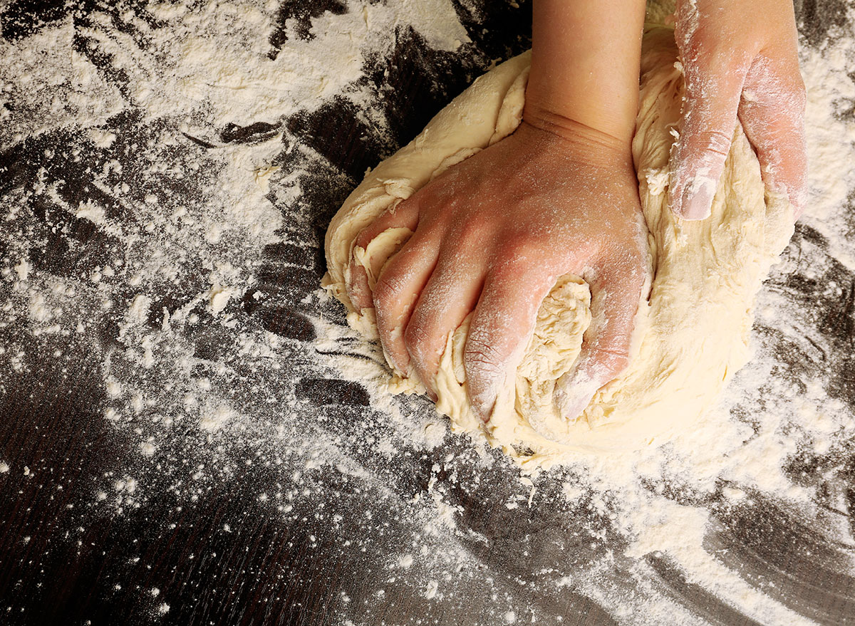 female hands making dough
