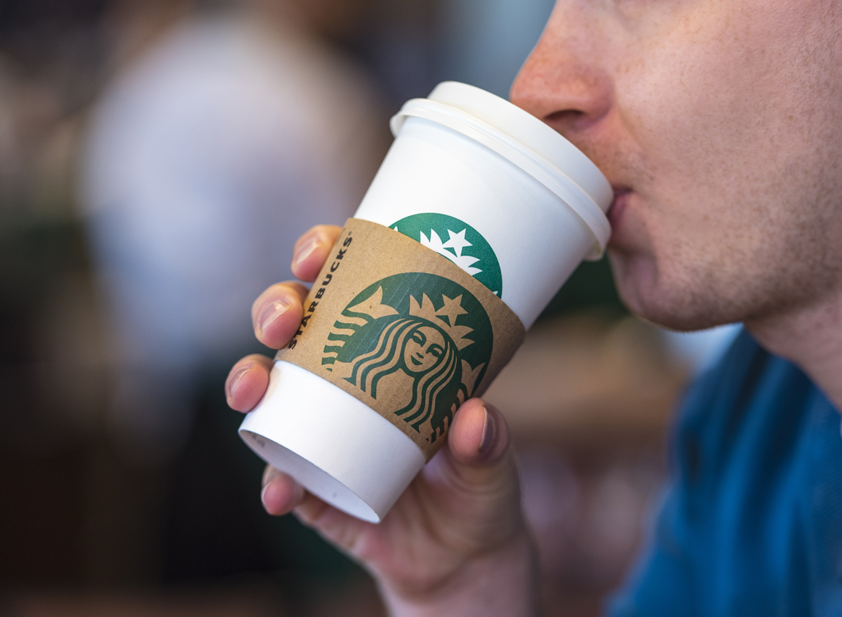 Man drinking starbucks coffee