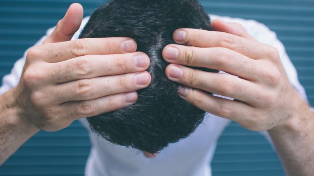 A picture of brunette showing his hair on head