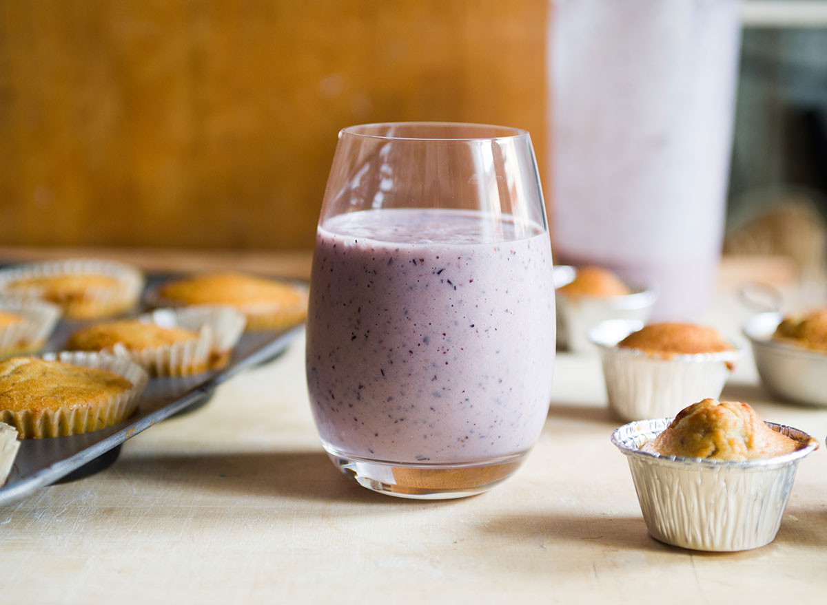 blueberry smoothie with muffins in tin