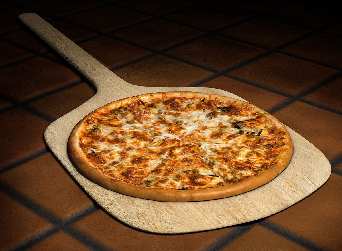 Pizza on wooden pizza peel