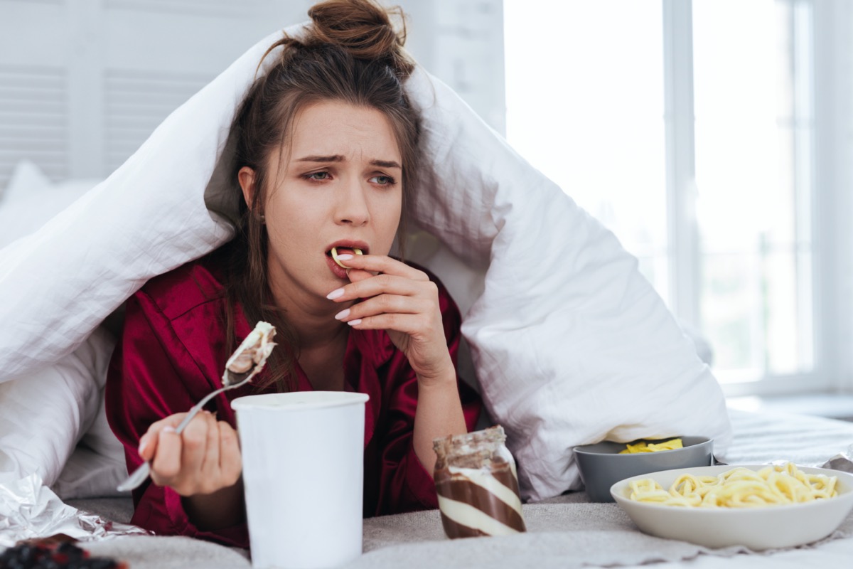 sick-woman-cold-flu-eating-food-soup-bed