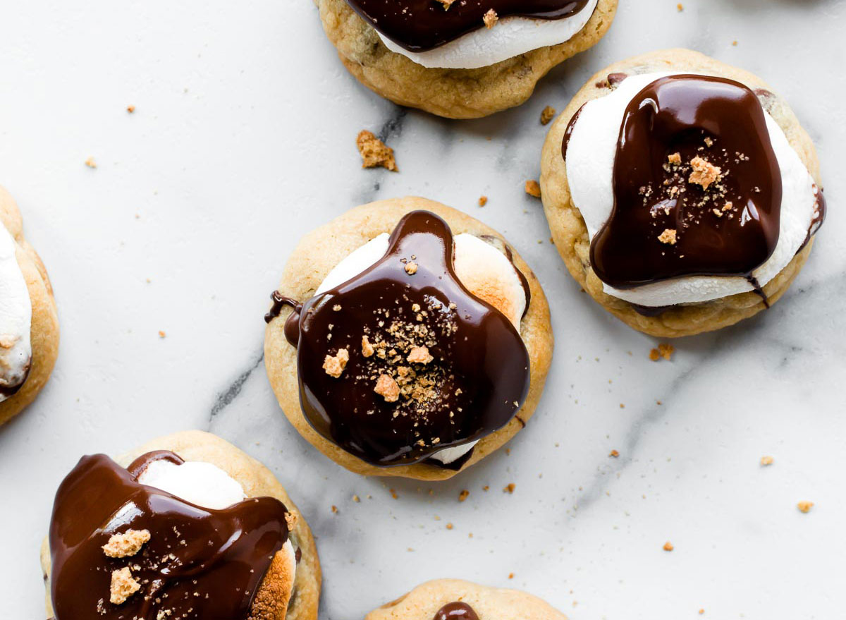 chocolate chip smores cookies topped with marshmallows and fudge