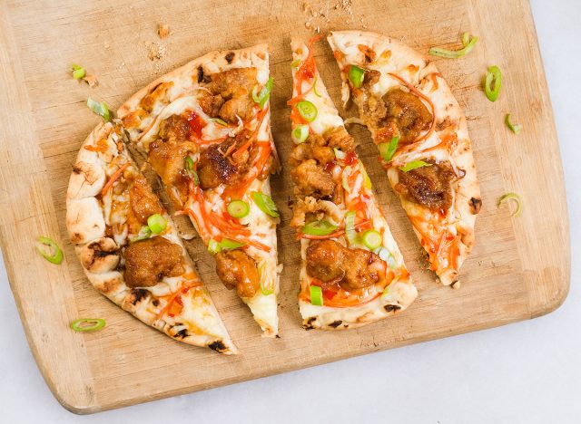 orange chicken flatbread on a cutting board