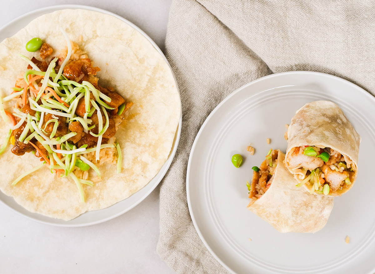 orange chicken burritos on grey plates