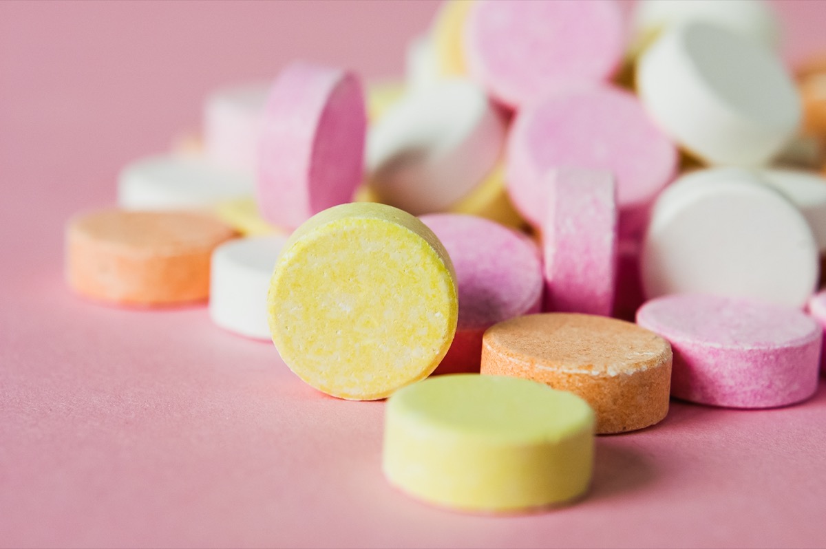 pile of chewable antacid acid reducer tablets with fruit flavor in pastel colors