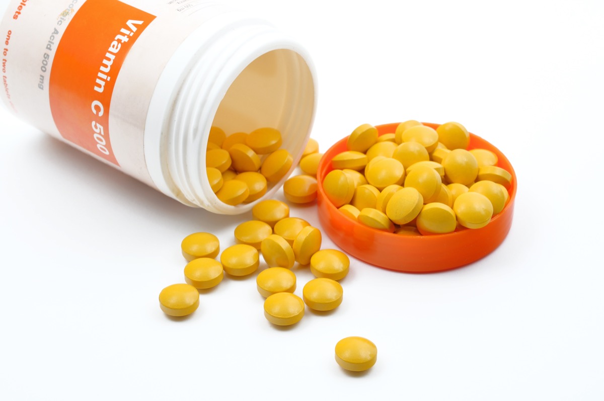 Vitamin C pills spilling out of a jar