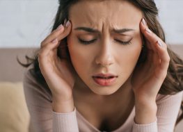 woman with closed eyes suffering from headache