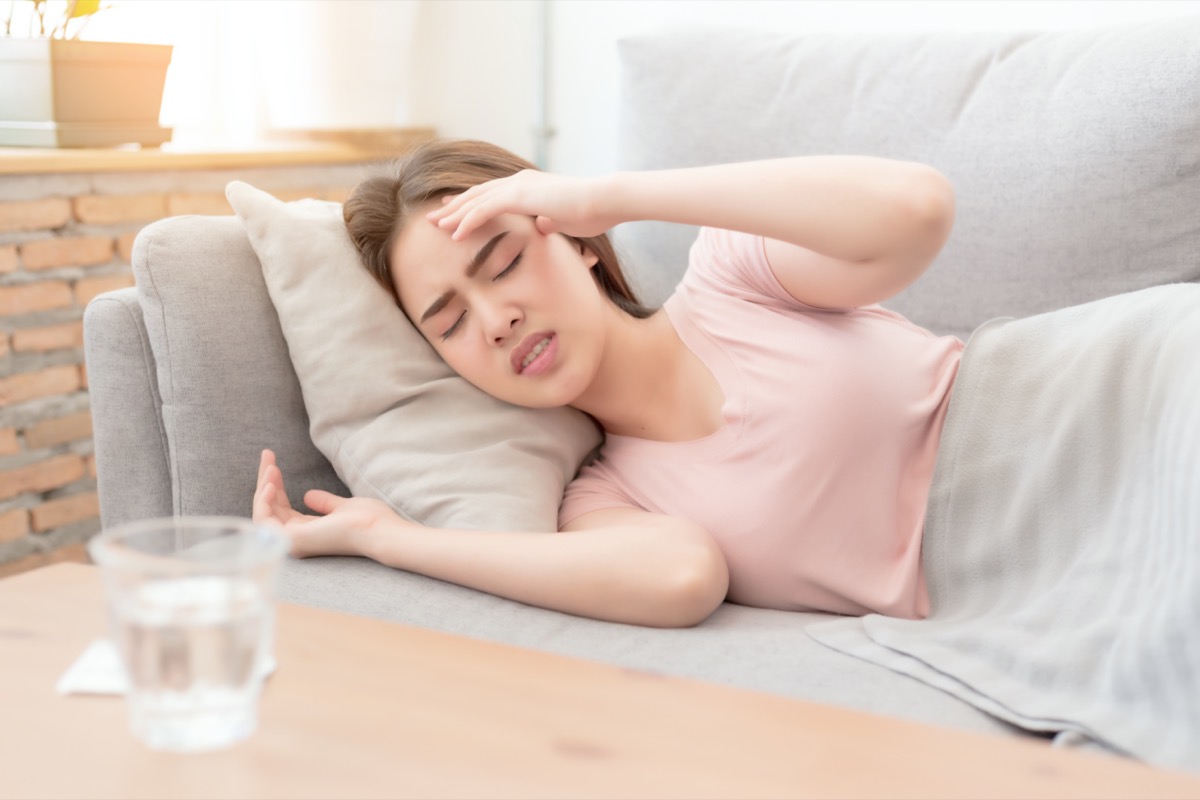 woman with a headache on sofa