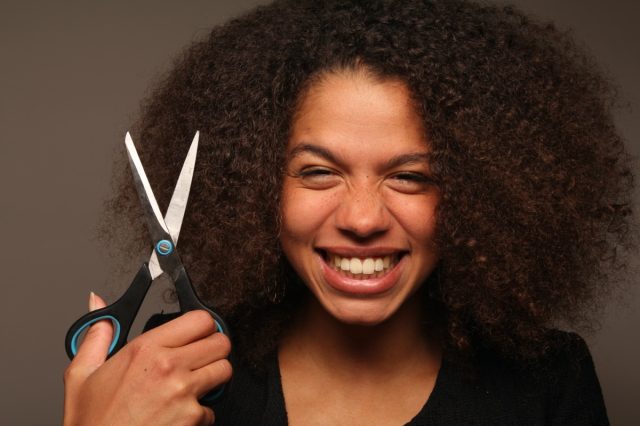 Beautiful afro women posing with scissor