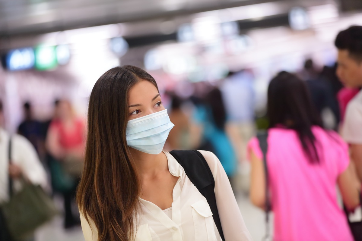 Person wearing protective mask against transmissible infectious diseases and as protection against pollution and the flu