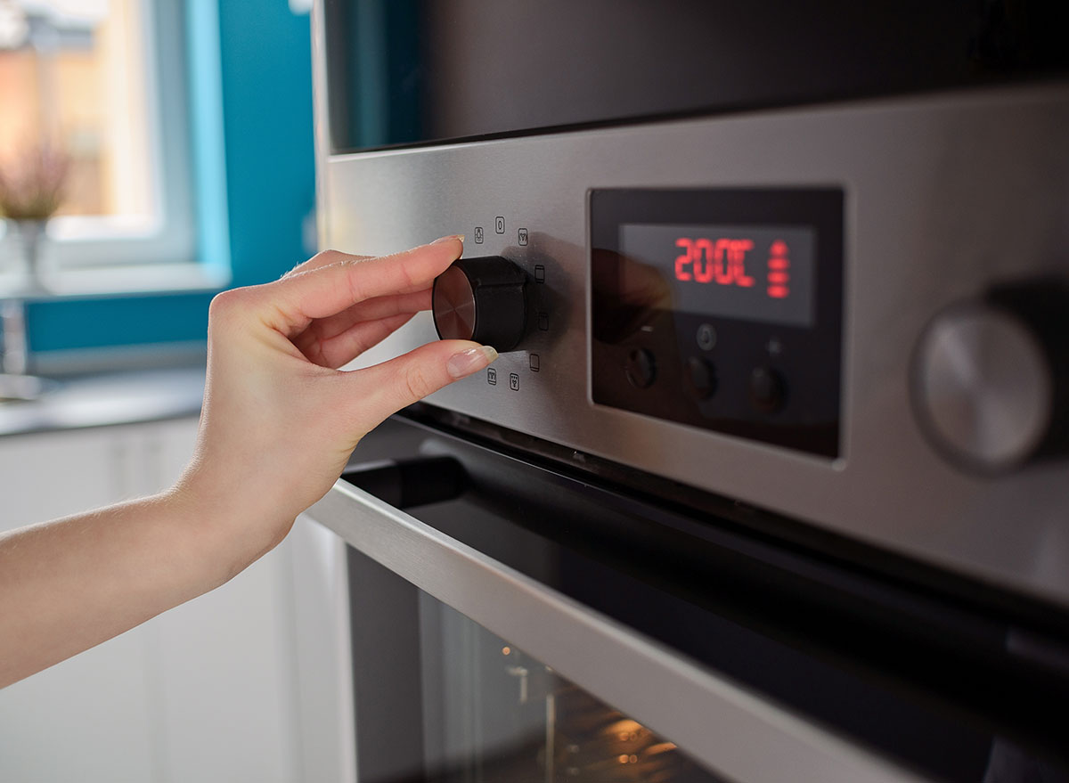 Women regulating oven temperature