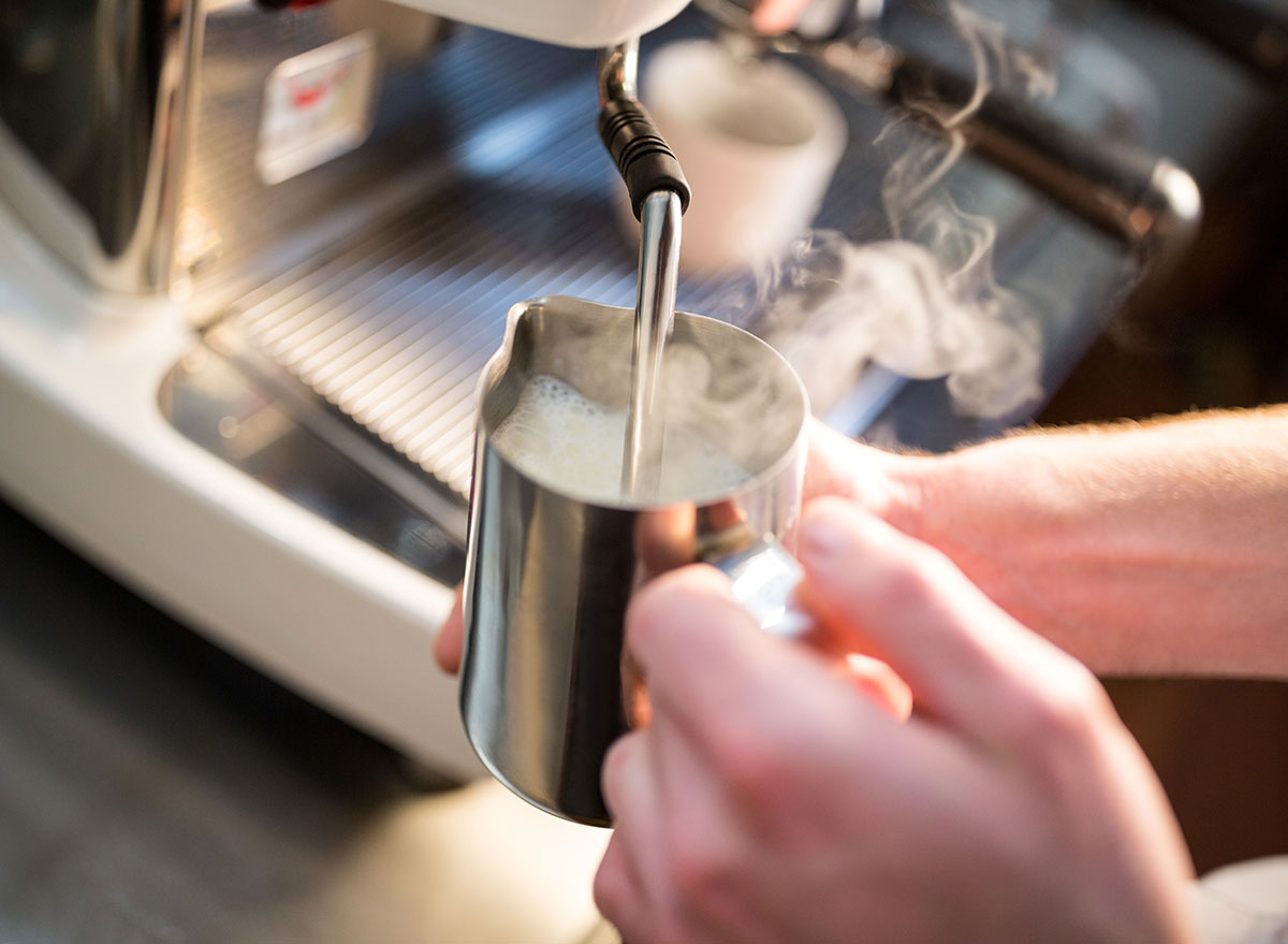 Barista steaming milk