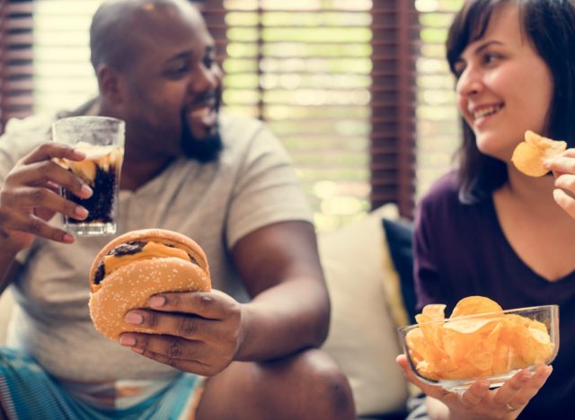 Couple having fast food on the couch