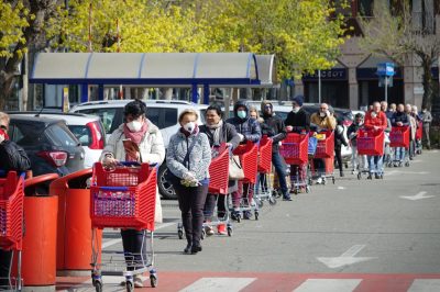 Coronavirus pandemic effects: long queue to enter the supermarket for grocery shopping