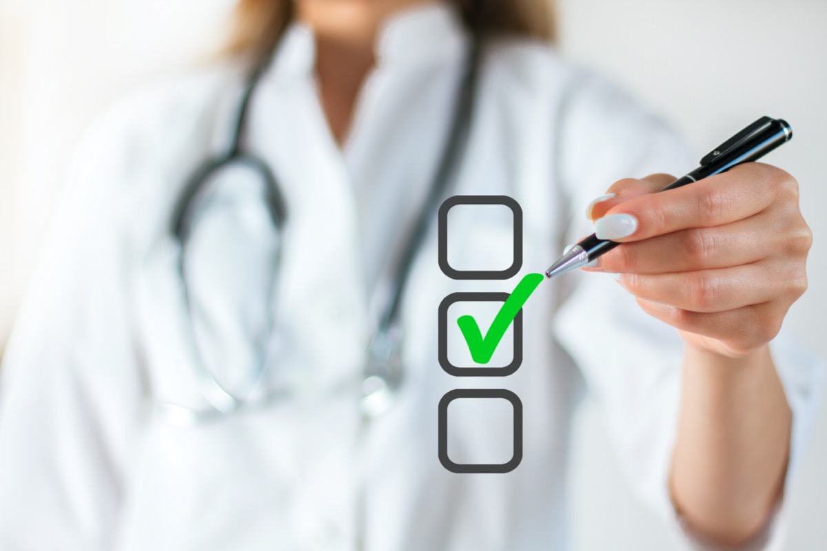 Doctor hand check with pencil in checkbox positive sign