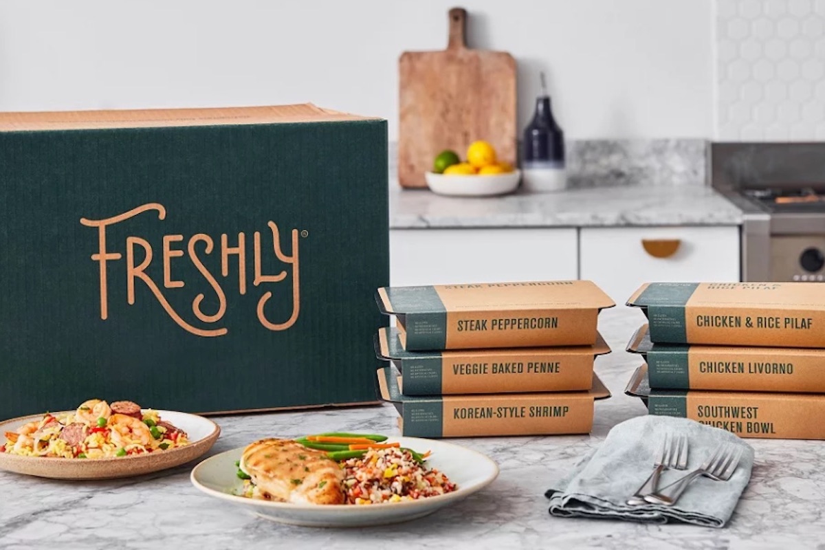 freshly meal boxes on table with meal on plate