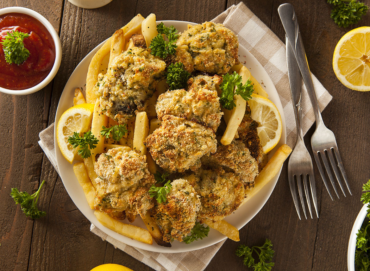 plate of fried oysters with fries and dipping sauce