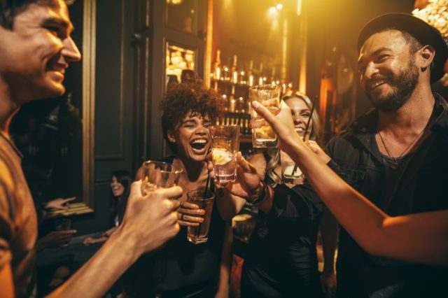 Group of friends having drinks at nightclub.