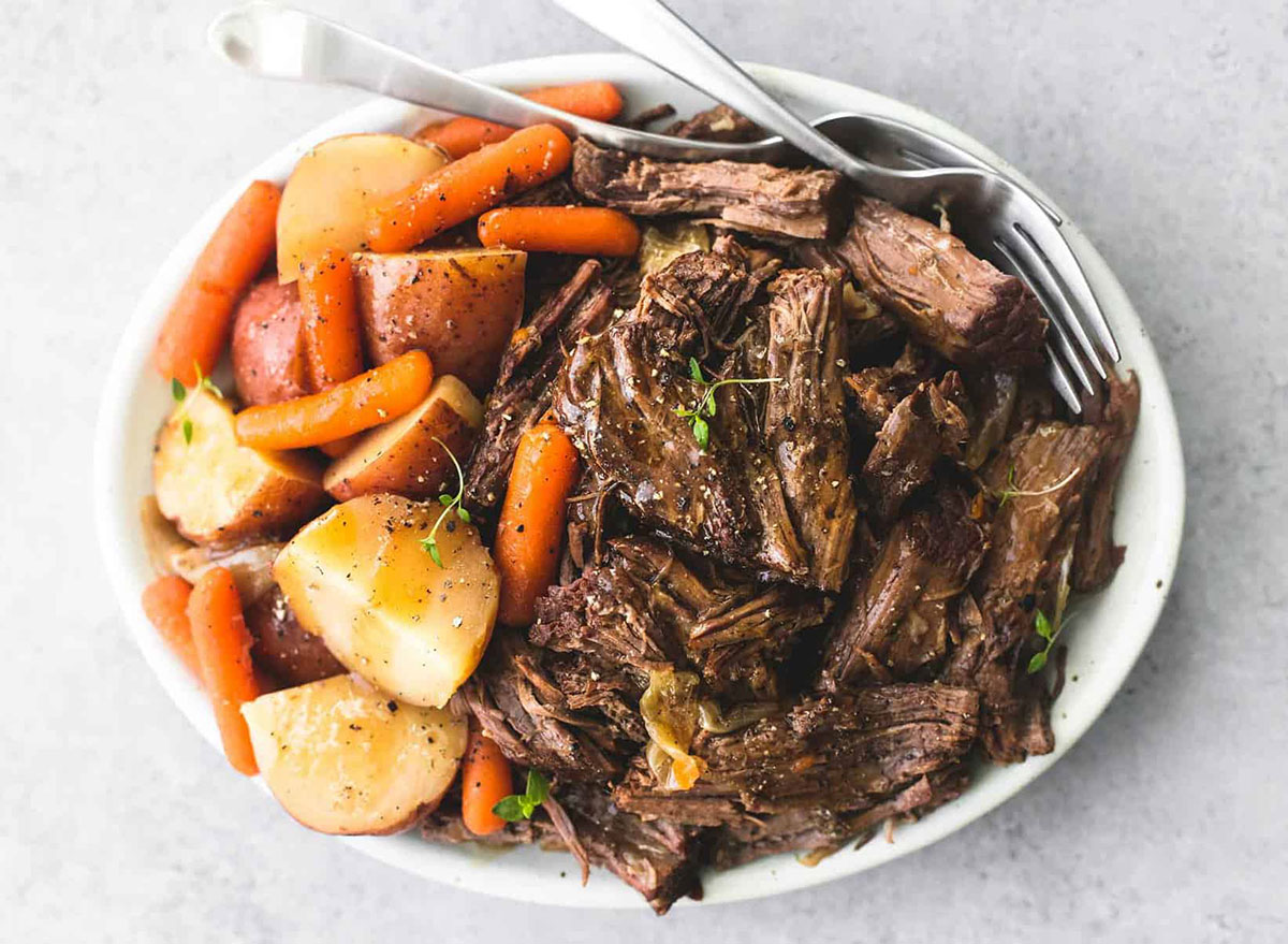 pot roast with potatoes and carrots on white plate