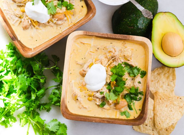 white chicken chili in two bowls with cilantro