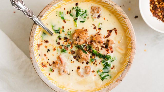 instant pot zuppa toscana in a bowl with red pepper flakes