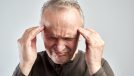 An old man touches his head. Headache. Alzheimer's disease