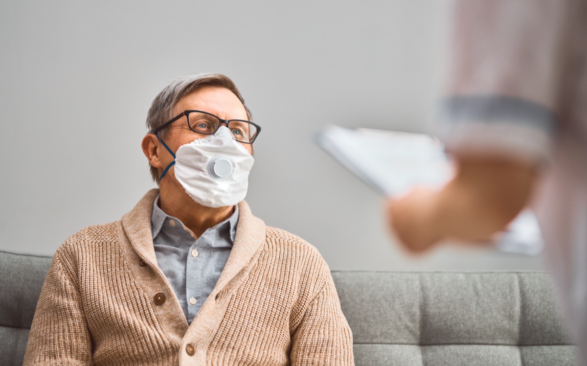 Doctor and senior man wearing facemasks during coronavirus and flu outbreak