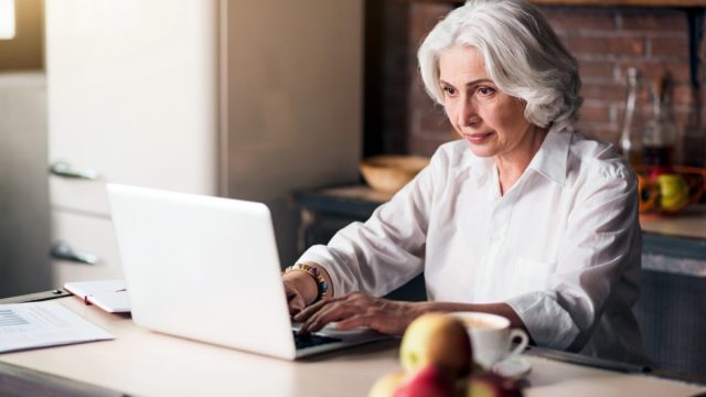 older woman looking at laptop