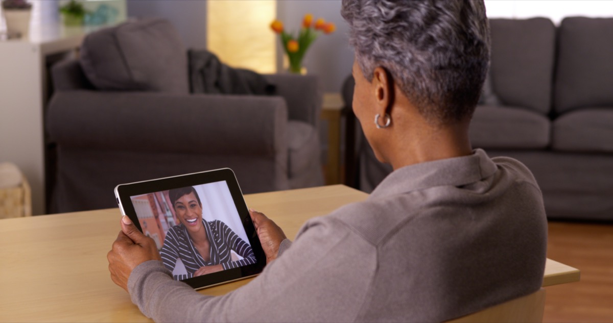 African grandma video chatting on tablet