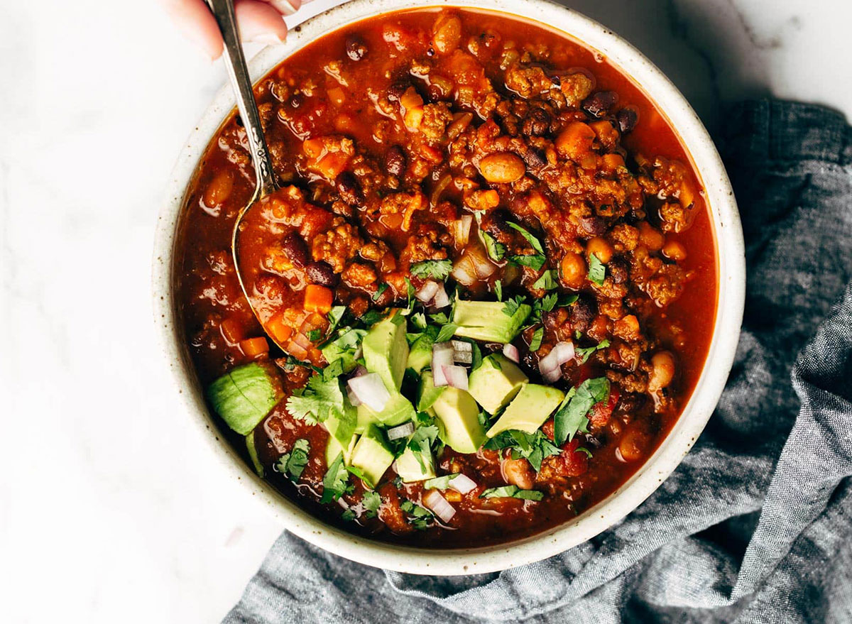 bowl of sunday chili topped with avocado