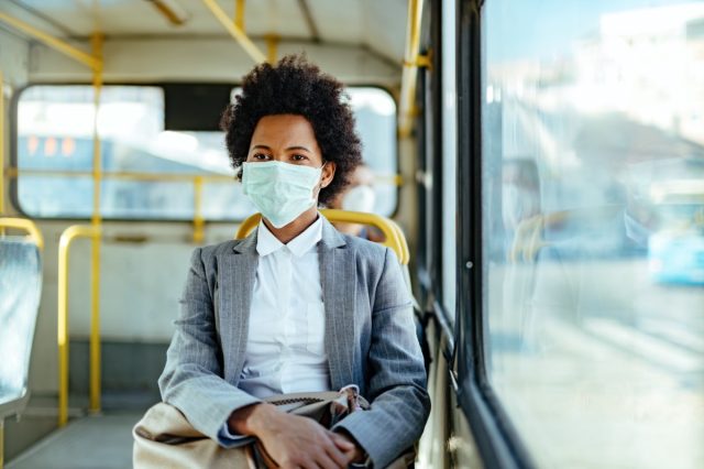 sinesswoman wearing protective mask while traveling by public transportation.