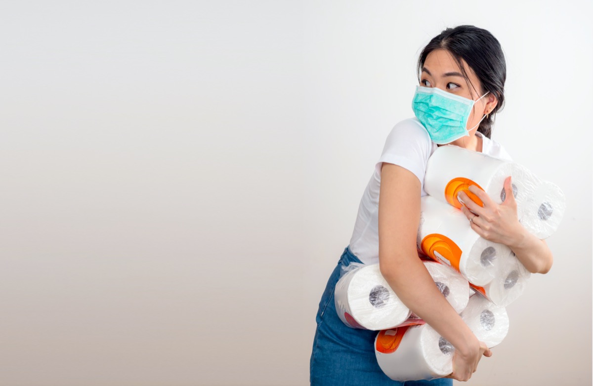 An Asian woman storing tissue toilet paper during Coronavirus outbreak or Covid-19, Concept of Covid-19 quarantine