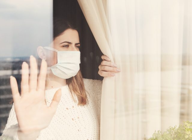 woman in medical mask stay isolation at home for self quarantine